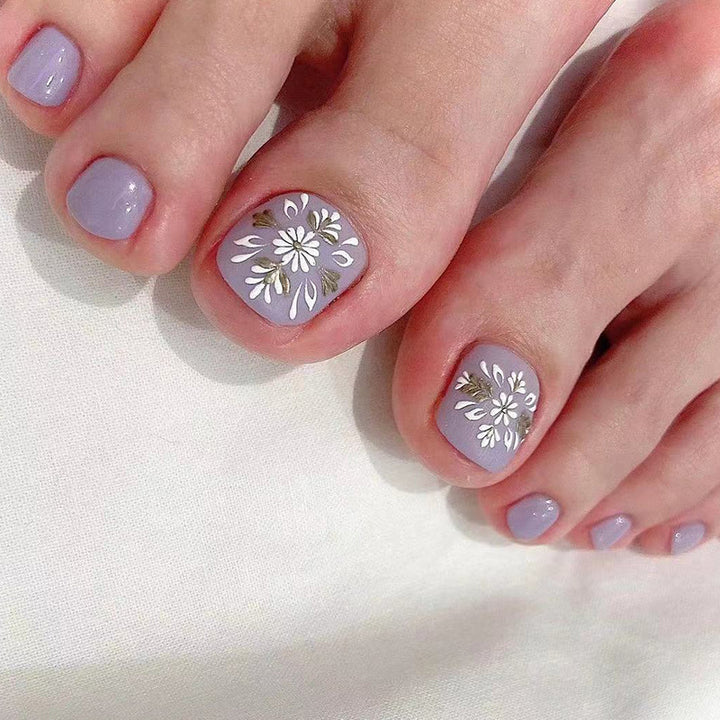 Artistic toenail design with elegant floral design Kalsten