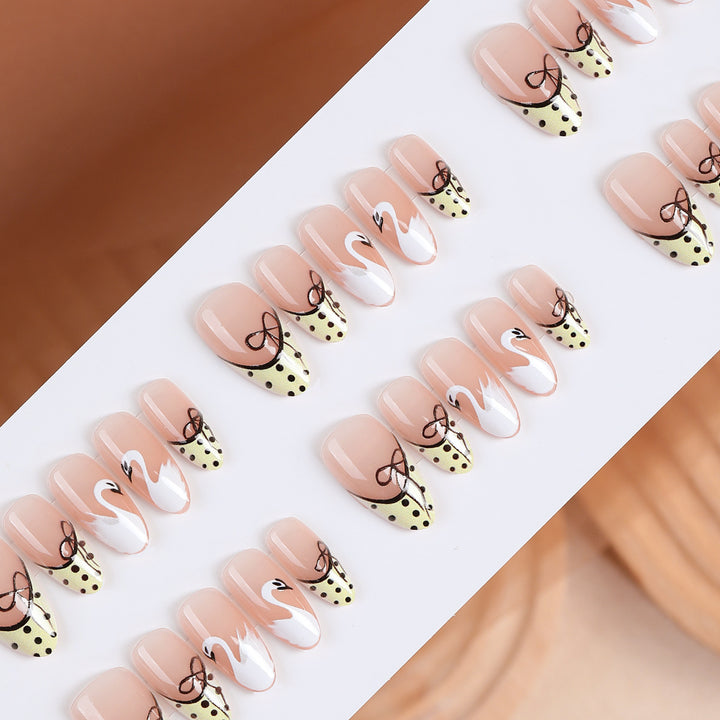 Art nail set with creative swan design and playful dots Kalsten