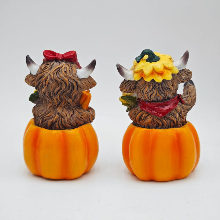 Funny decorative figure of a Highland cow in pumpkin costume Kalsten