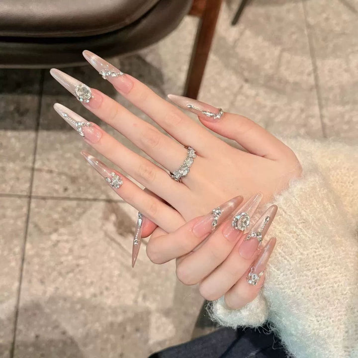 Acrylic nail set with elegant tips and glamorous rhinestone accents Kalsten