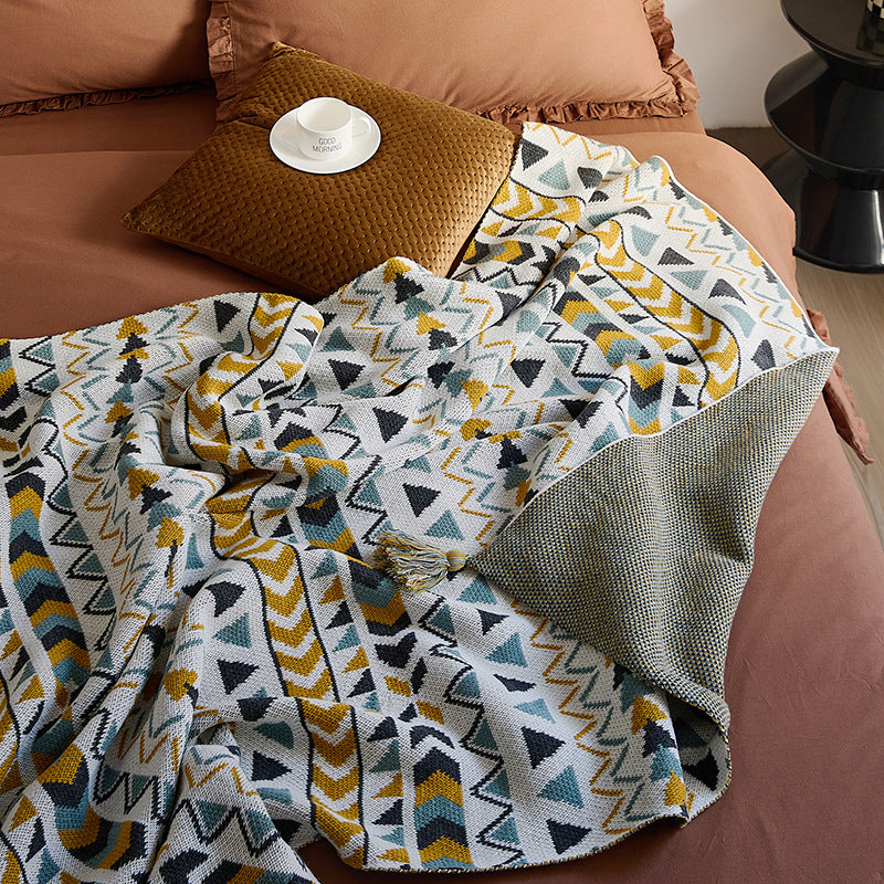 Patterned throw blanket in ethnic knit design with tassels