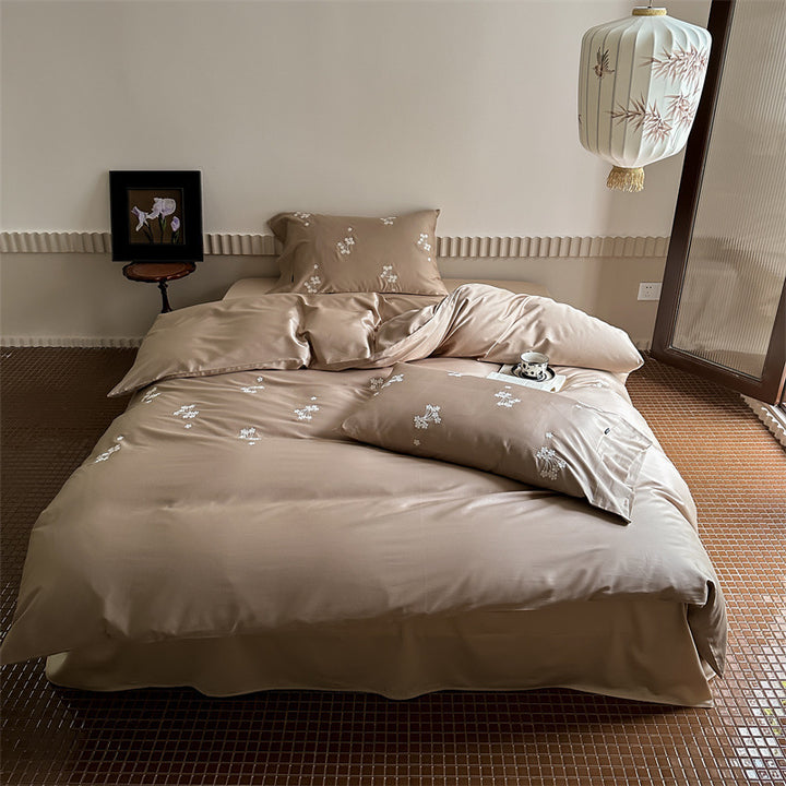 Elegant satin bed linen set with subtle floral embroidery and silk-like sheen
