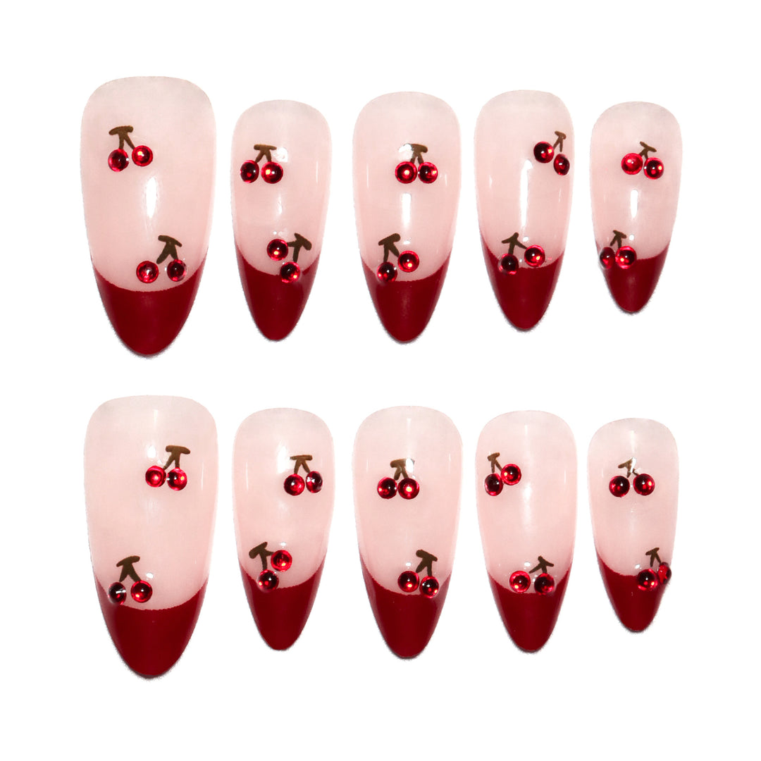 Artful stiletto nails with cherry motifs and glitter accents Kalsten