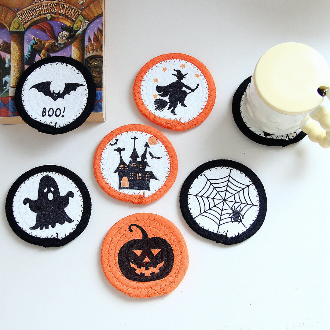 Round felt and cotton coasters with embroidered Halloween haunted house motif