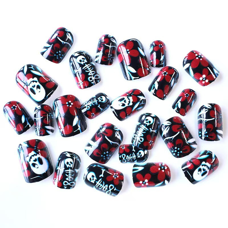 Artificial nail set with creepy skull design and floral accents Kalsten