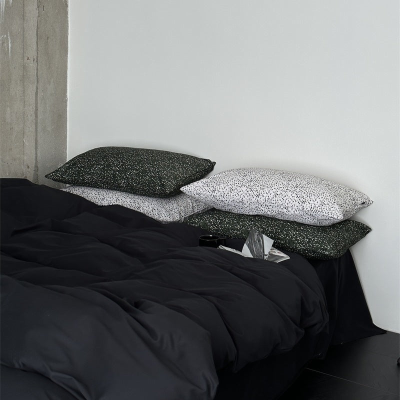 Modern satin bedding set with quilted look and patterned pillowcases