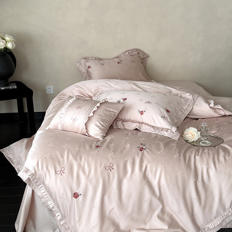 Luxurious satin bedding set with delicate floral embroidery and ruffles