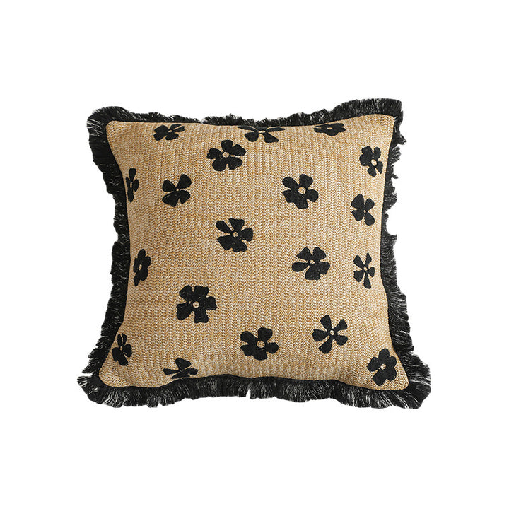 Rectangular woven decorative pillow with contrasting flower tufting and fringe trim