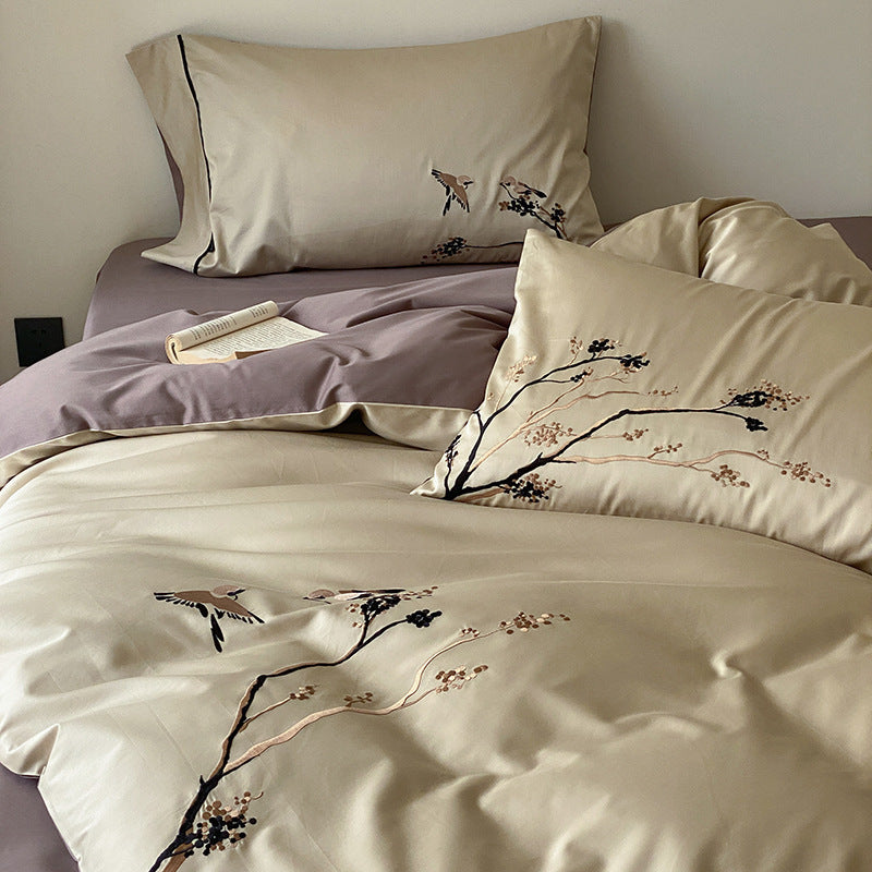 Reversible cotton satin bed set with finely embroidered bird and branch motifs
