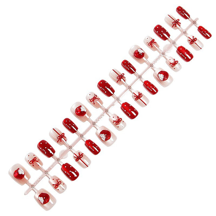Artificial nail set with festive gift design and elegant glitter accents Kalsten
