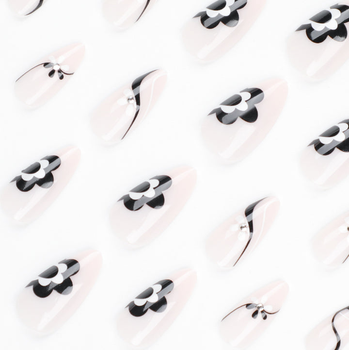Artistic nail extensions with floral accents and glitter accents Kalsten