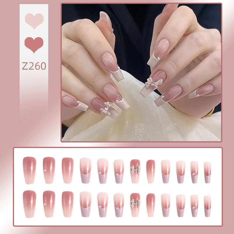 Artificial nail set with elegant ombre design and delicate bow embellishments Kalsten