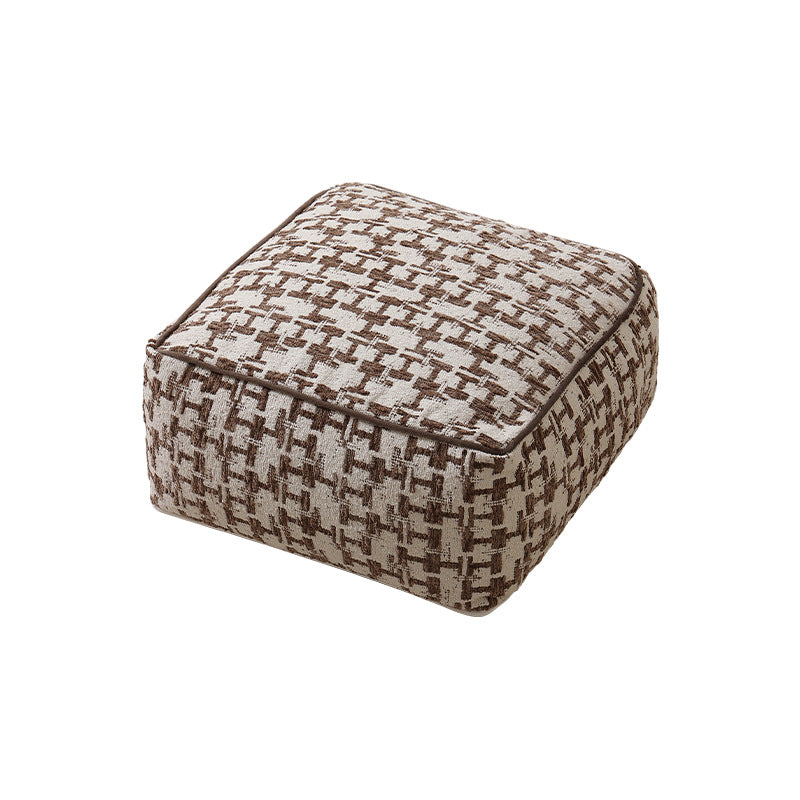 Square floor pouf with houndstooth jacquard, piping seam, and shape-stable foam core
