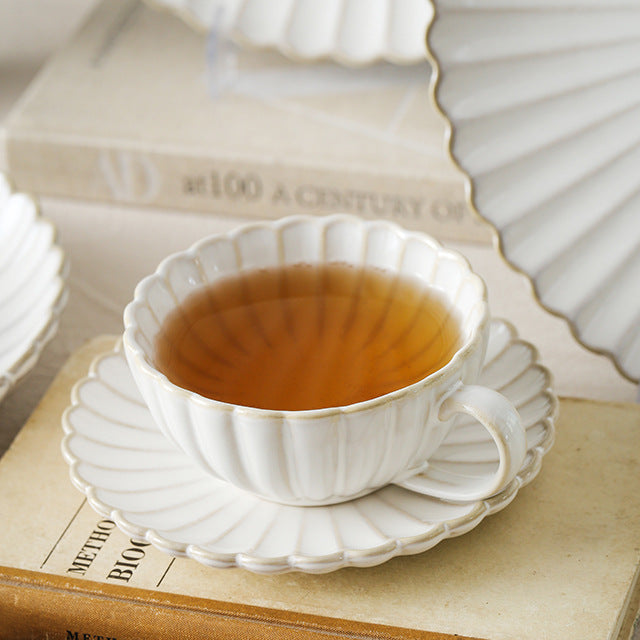 Fine porcelain tea cup set with ribbed shell edge and sculptural handle