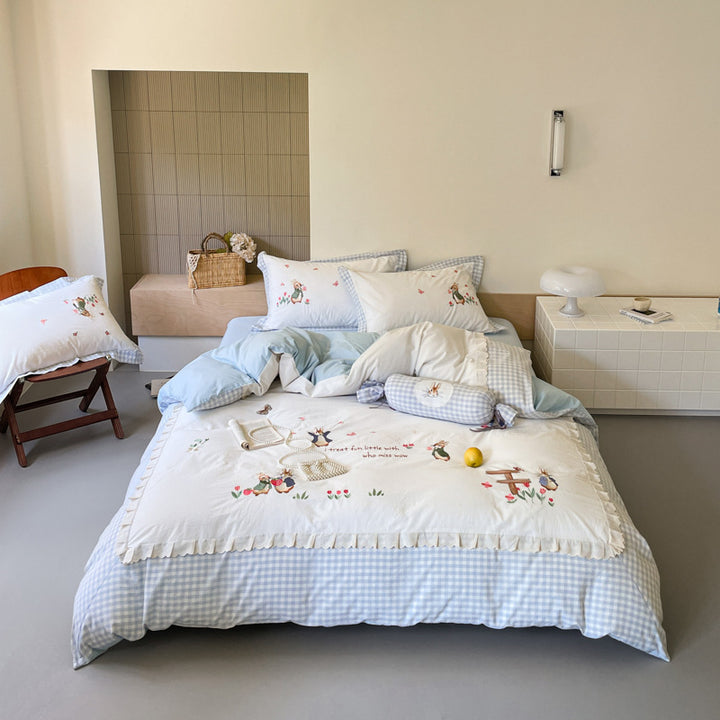 Romantic bedding set with embroidered rabbit motifs and delicate ruffles