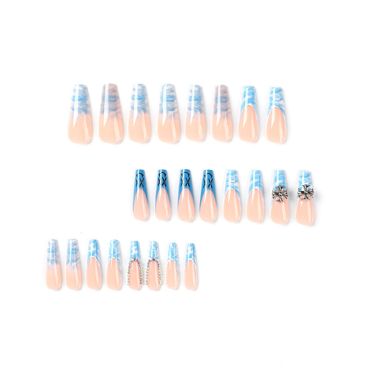 Artistic acrylic nails with marbled design and unique embellishments Kalsten