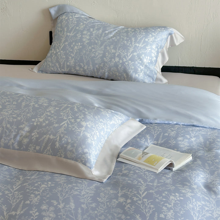 Luxurious satin bedding set with floral watercolor print, ruffled edges and reversible function
