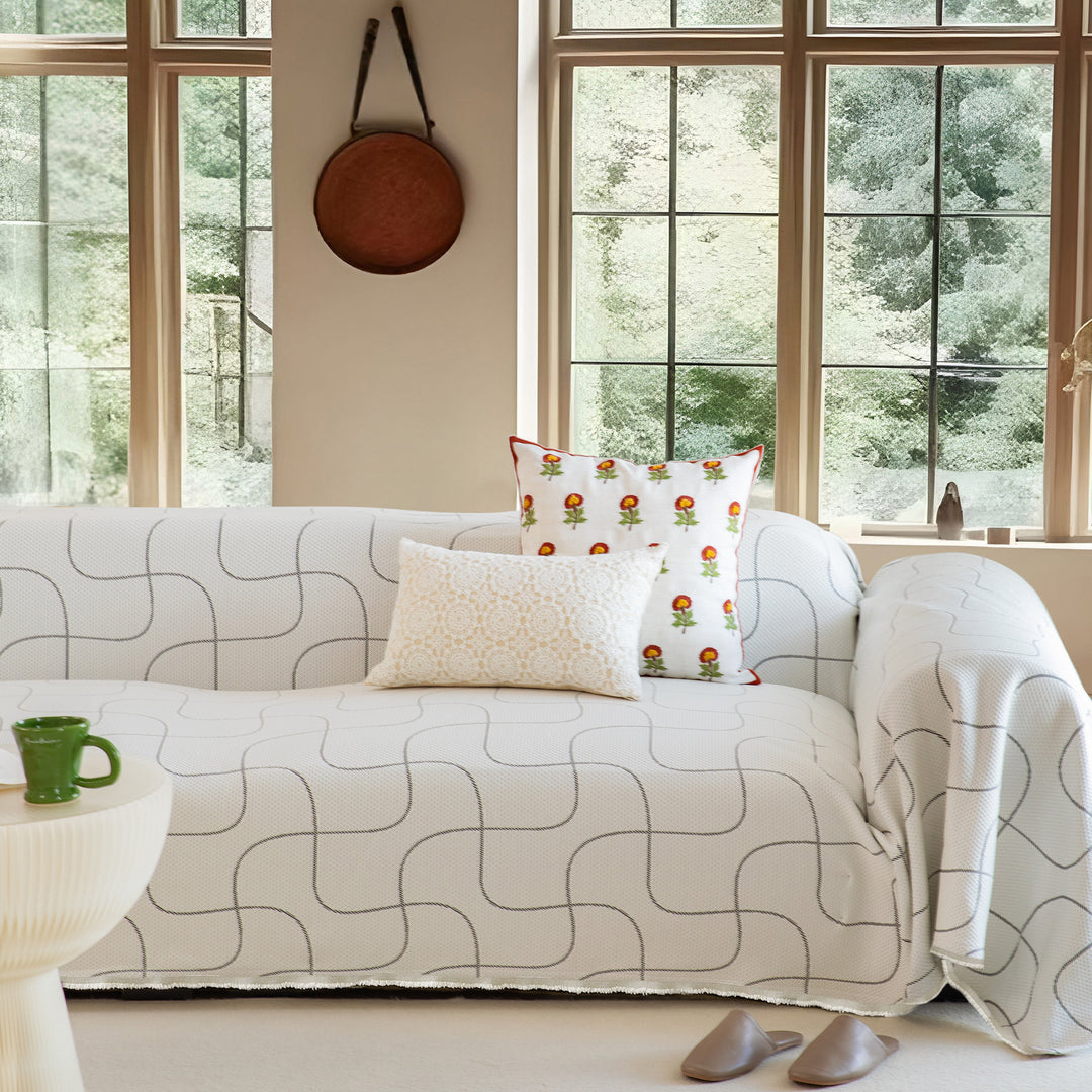 Washable sofa cover with geometric jacquard pattern and non-slip underside