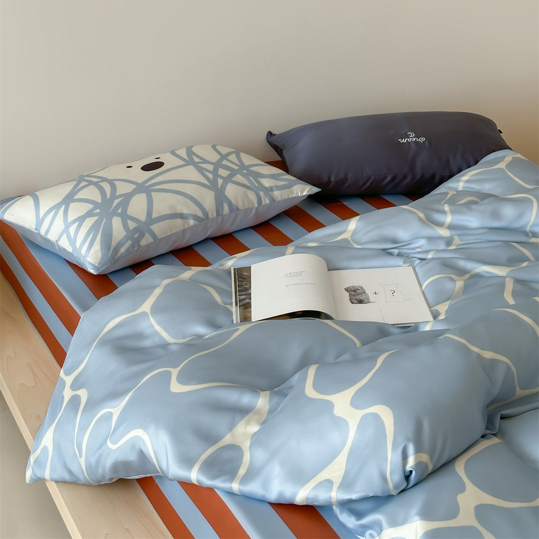 Luxurious satin bedding set with floral watercolor print, ruffled edges and reversible function