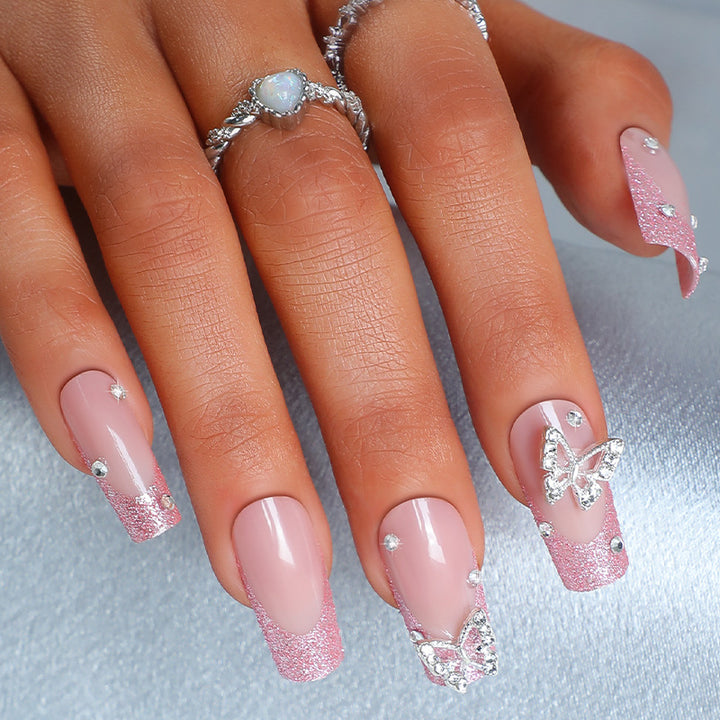Acrylic nail set with sparkling glitter accents and elegant butterfly motifs Kalsten