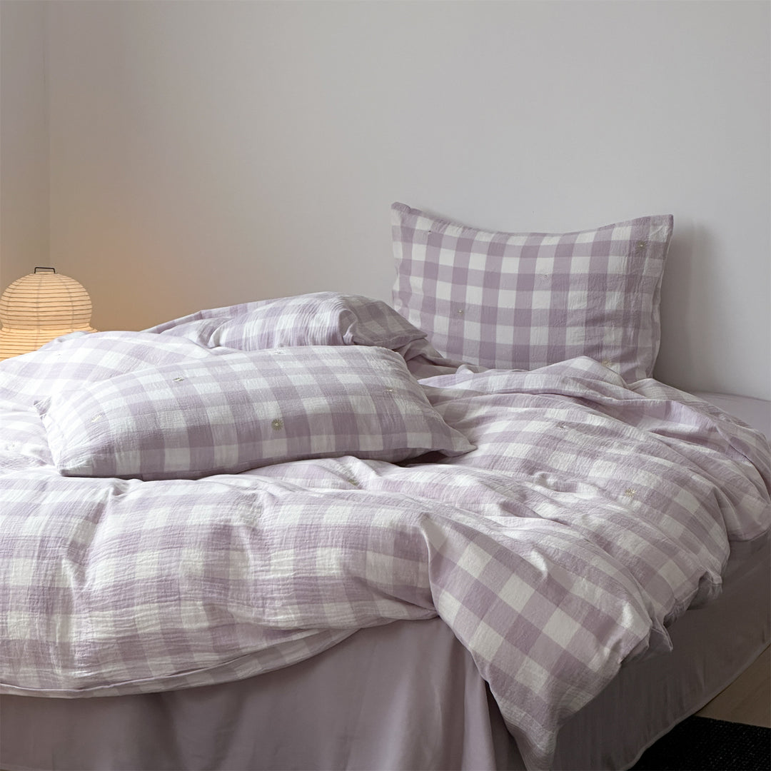 Duvet cover set made of lightweight cotton muslin featuring a checked texture and decorative embroidery design