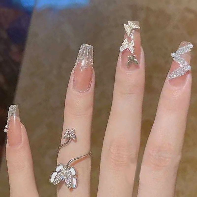 Artificial nails with sparkling rhinestone and bow accents Kalsten