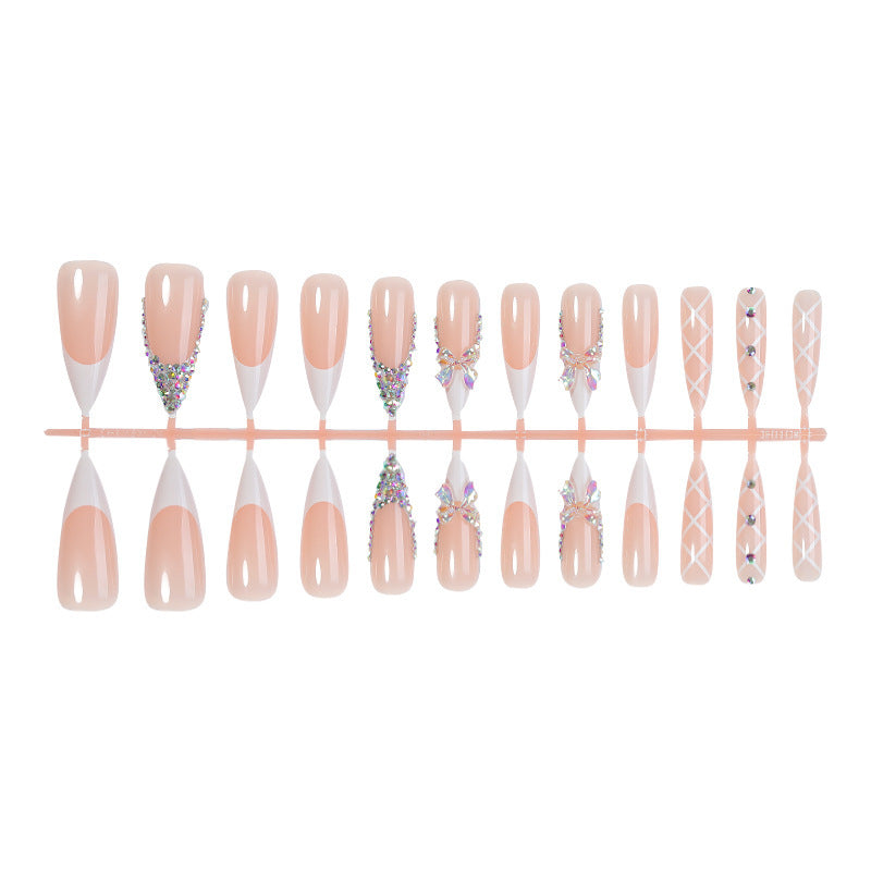 Acrylic nail set with luxurious rhinestone embellishments and bow accents Kalsten
