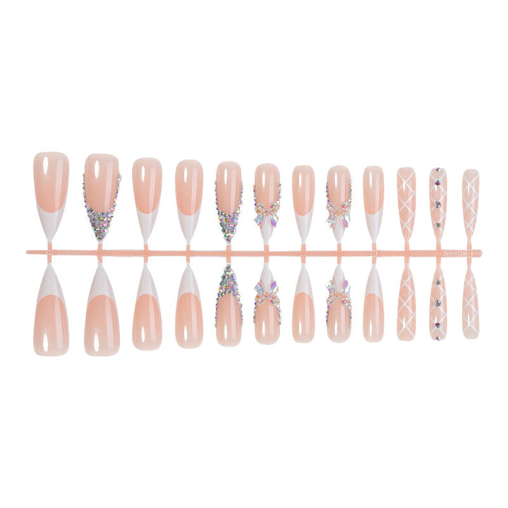 Acrylic nail set with luxurious rhinestone embellishments and bow accents Kalsten