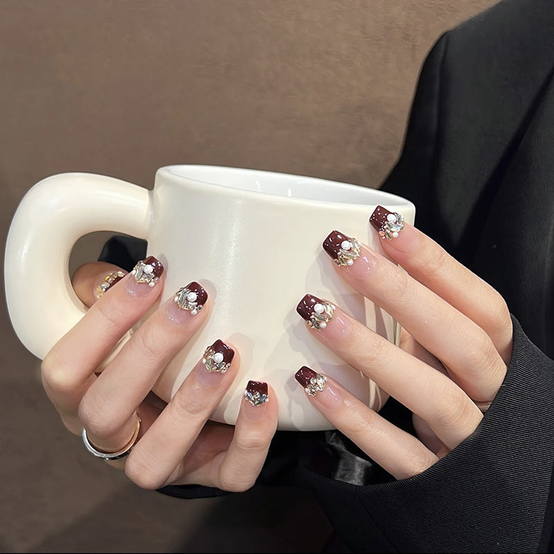 Glamorous artificial nails with decorative pearl and glitter embellishments Kalsten