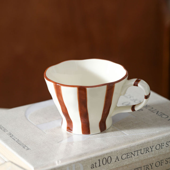 Designer stoneware coffee mug with scalloped rim and vertical brushstroke