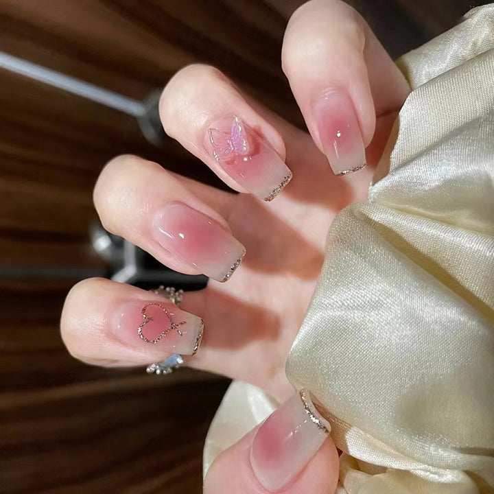 Artistic acrylic nails with heart and butterfly motifs Kalsten