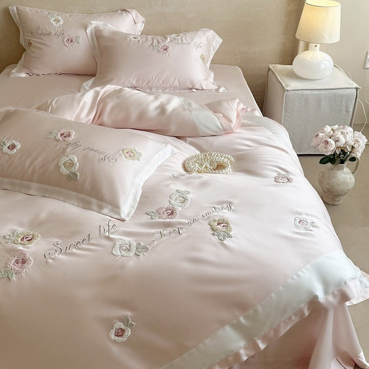Luxurious satin bedding set with embroidered rose appliqués and silky glossy finish