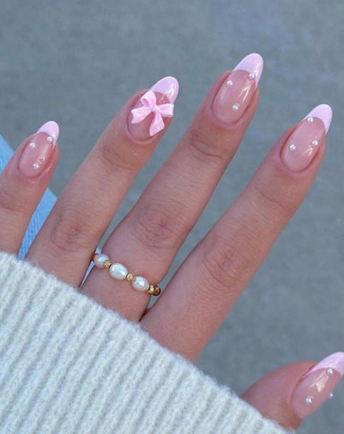Artificial nail set with shimmering 3D bows and elegant pearl accents Kalsten
