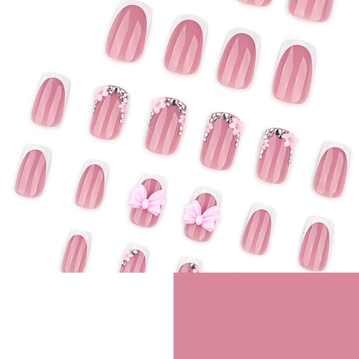 Artful nail extensions with sparkling accents and bow decorations Kalsten