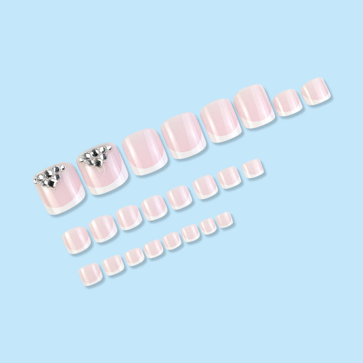 Nail art set with elegant French tips and sparkling rhinestone details Kalsten