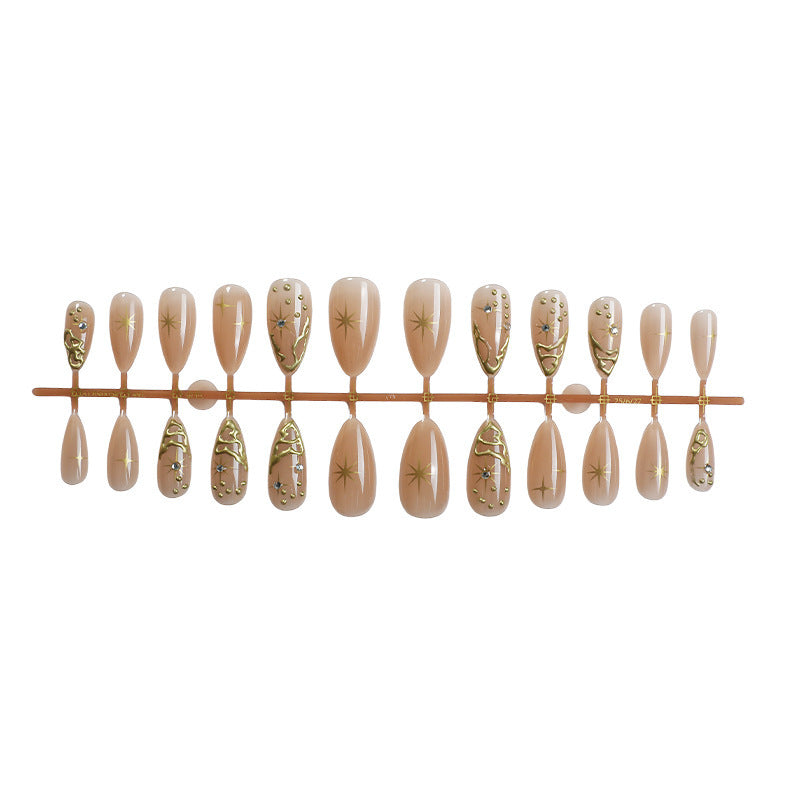 Creative nail set with elegant gold embellishments and sparkling accents Kalsten