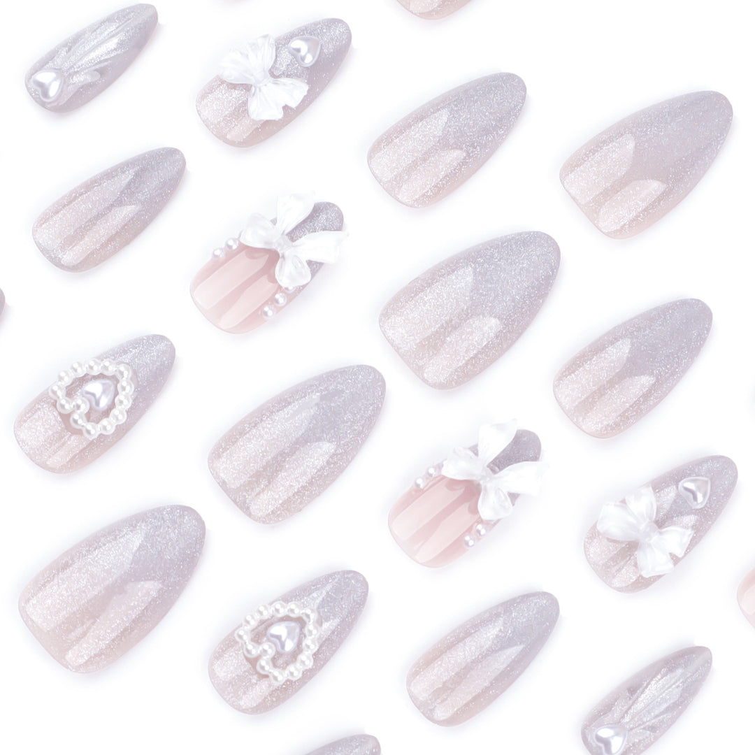Artful nail decoration with pearl and bow accents Kalsten