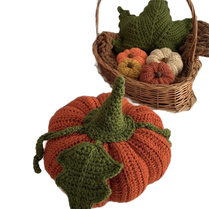 Hand-crocheted decorative cushion in pumpkin shape with leaf and vine application