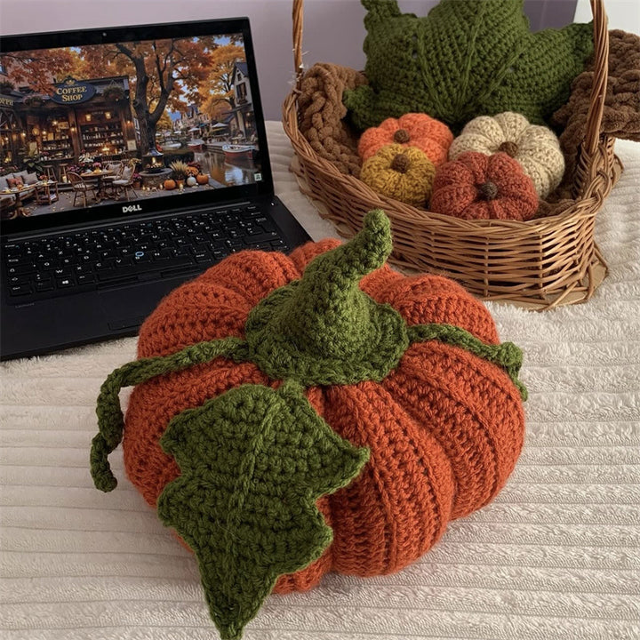 Hand-crocheted decorative cushion in pumpkin shape with leaf and vine application