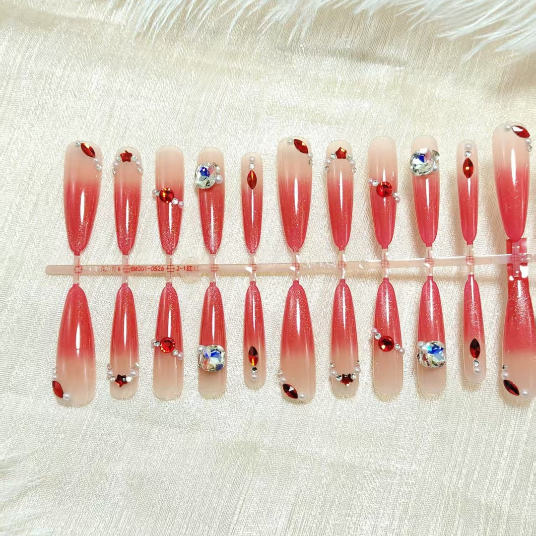 Artificial nails with glamorous glitter and rhinestone embellishments Kalsten
