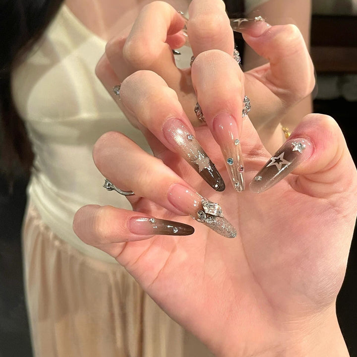 Glamorous artificial nails with sparkling rhinestone and star designs Kalsten