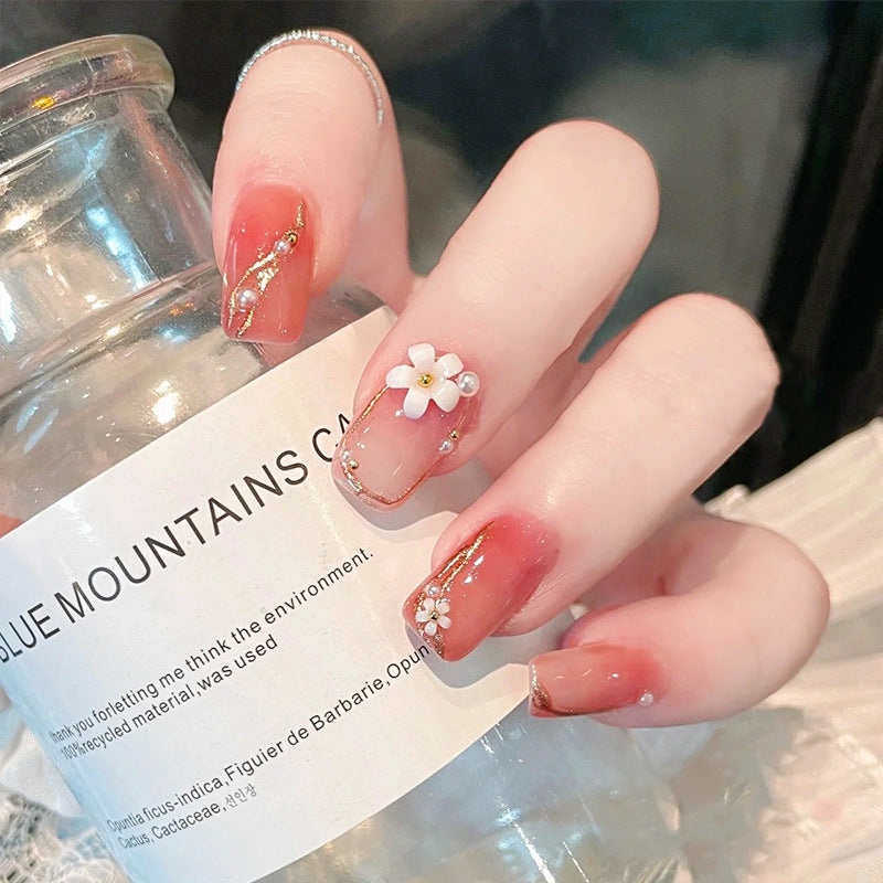 Acrylic nail set with elegant floral decorations and glamorous pearl accents Kalsten