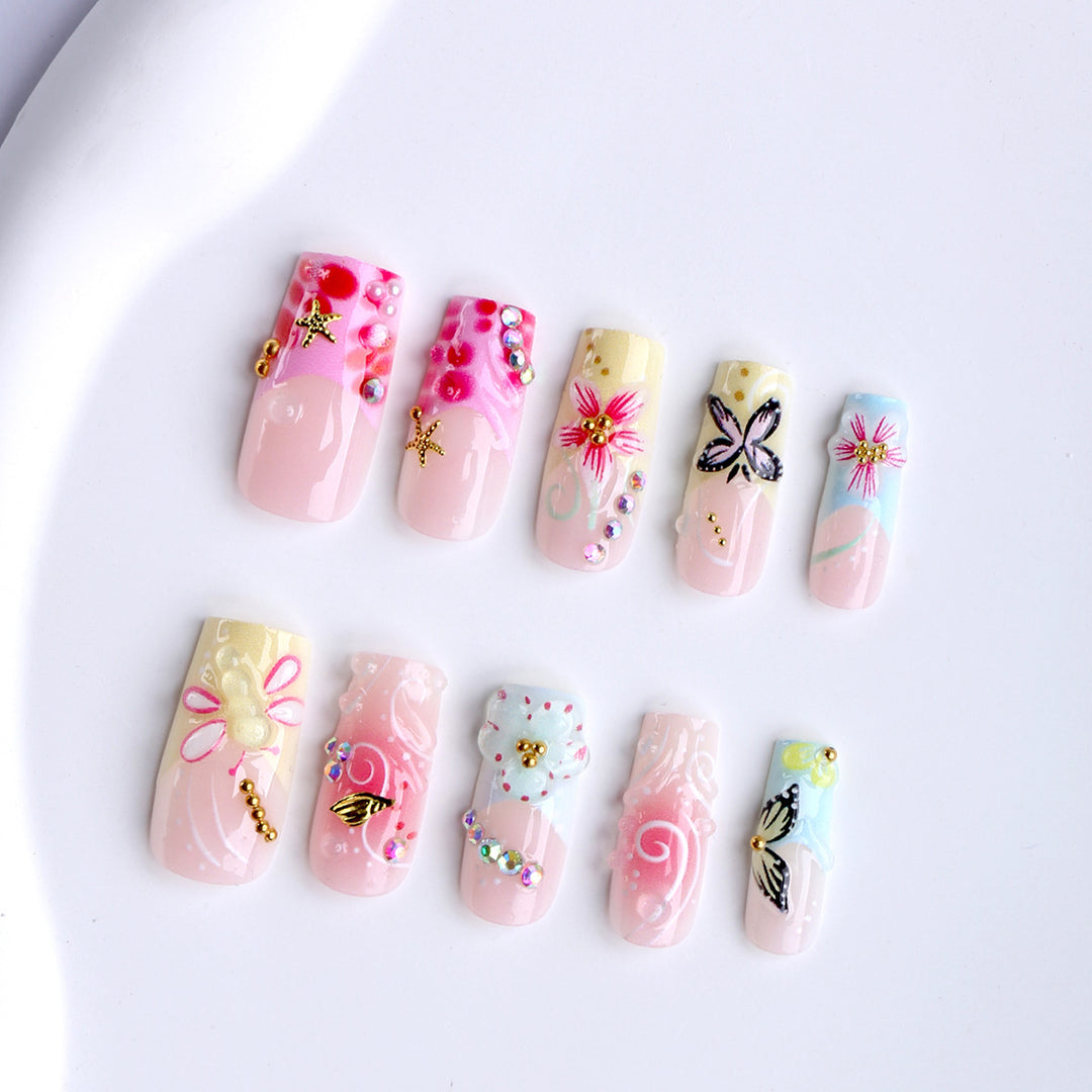 Artistic nails with floral accents and glitter clusters Kalsten