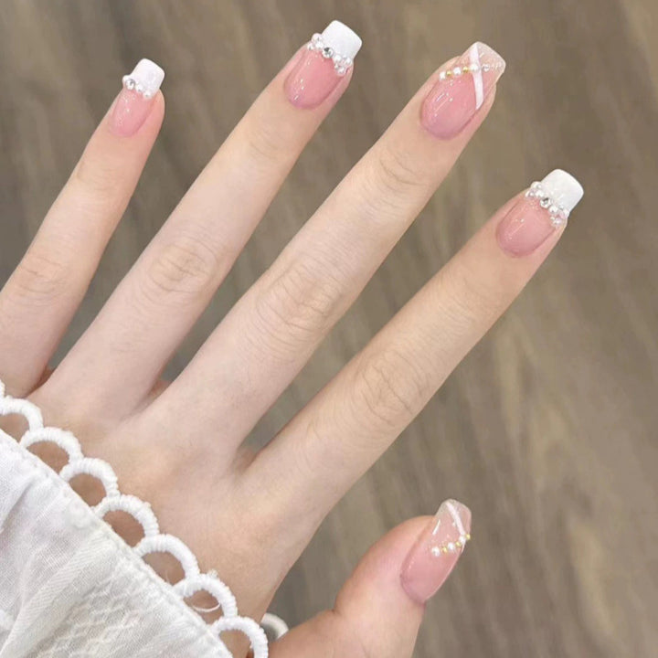 Elegant nail design with pearl embellishment Kalsten