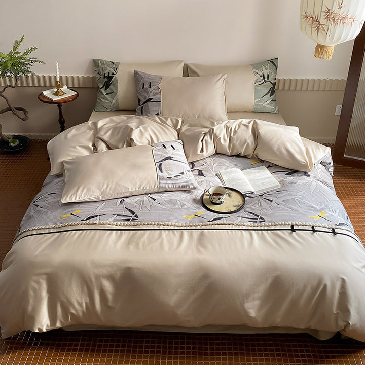 Reversible satin bedding set with quilted décor and botanical bamboo print