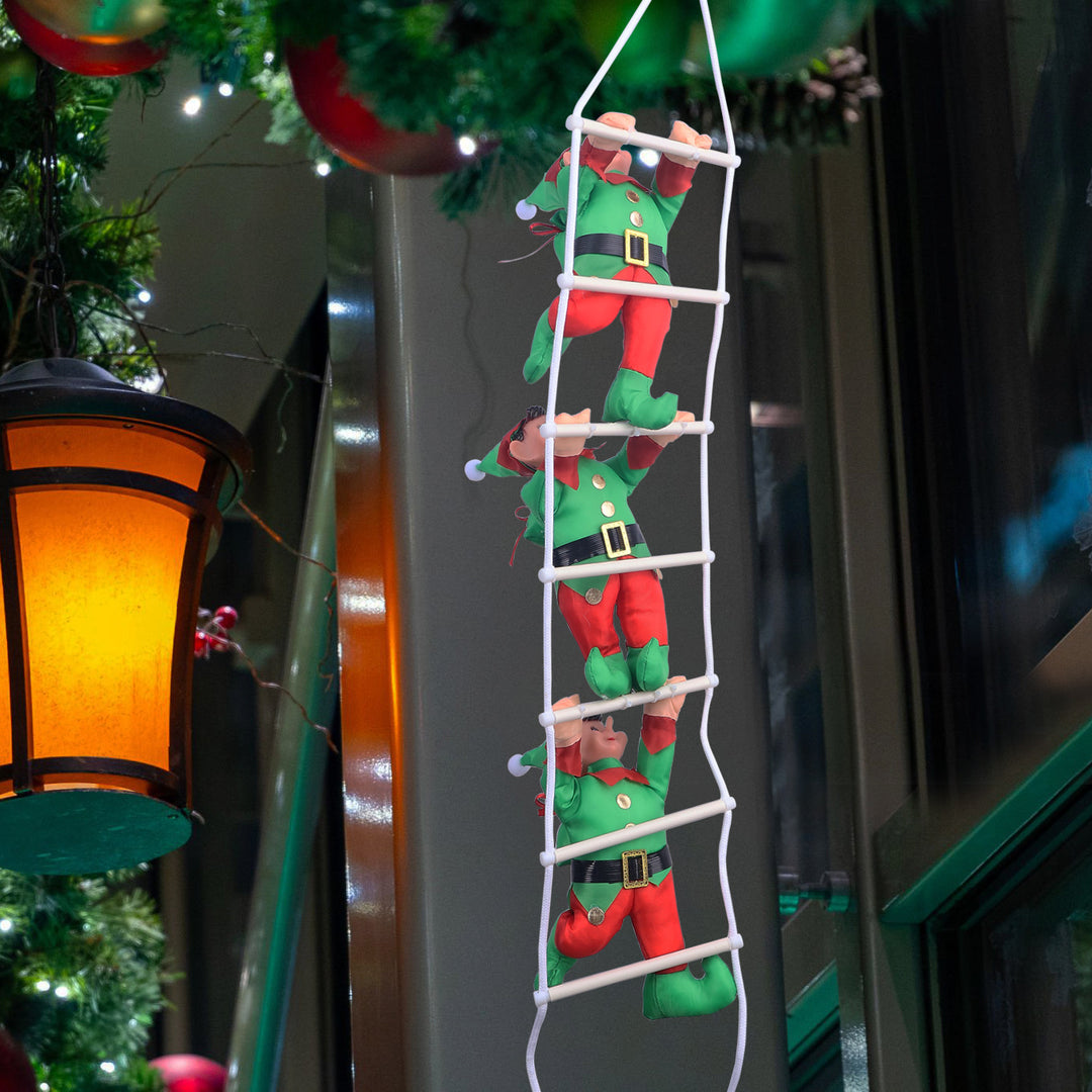 Inflatable Santa Claus figures climbing ladder