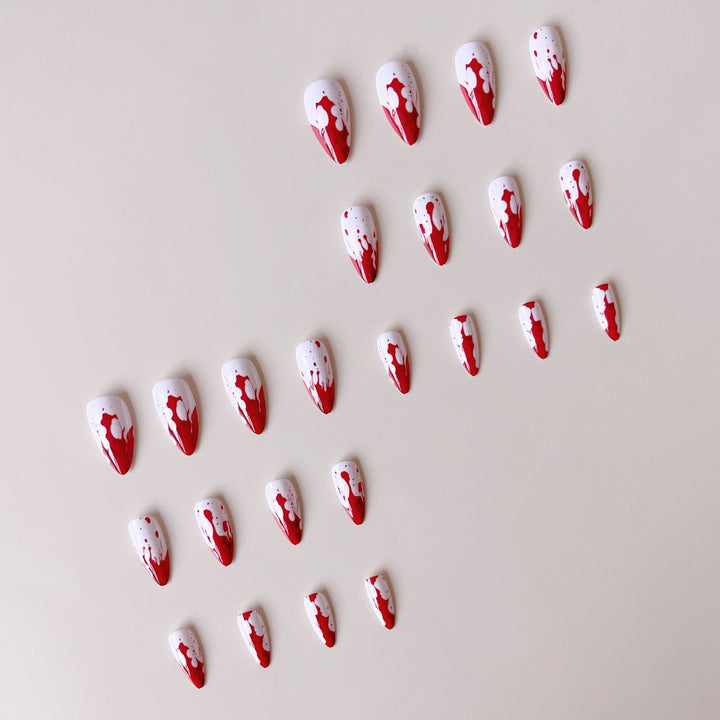 Artificial nail set with blood red inspired design and pointed accents Kalsten