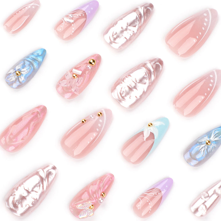 Artistic stiletto nails with delicate flower and glitter embellishments Kalsten