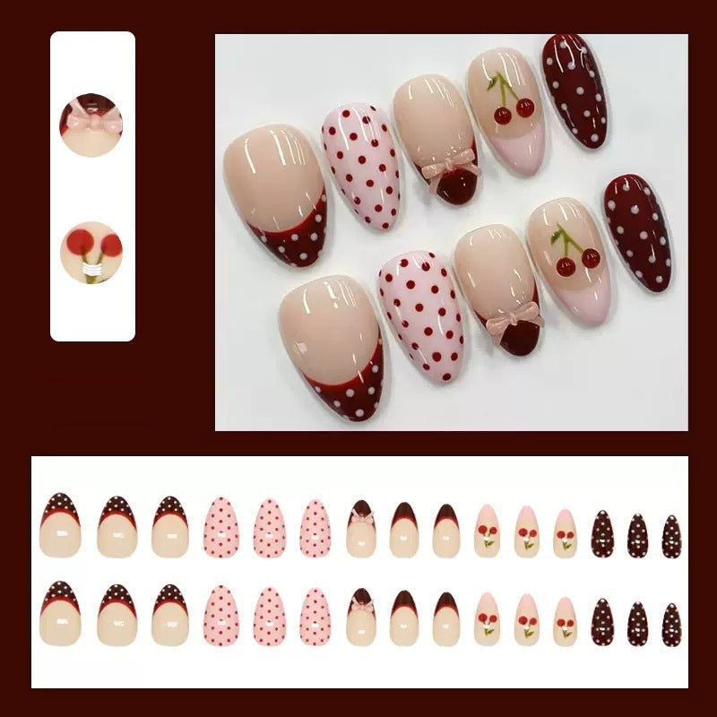 Artfully designed nail tips with cherry and dot motifs Kalsten