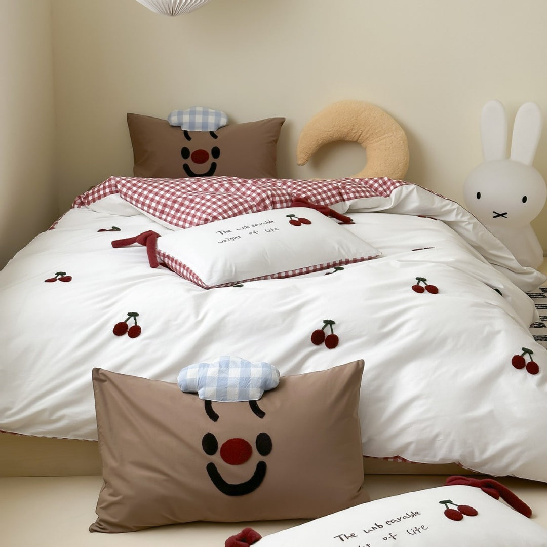 Children's bedding set with embroidered sprinkle appliqués, cuddle pillow and reversible function